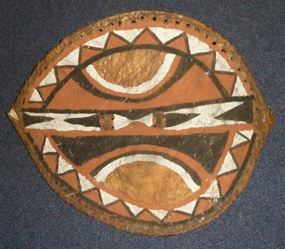 Lot 276 - A Masai Hide Dance Shield, painted with chevron bands and semi-circular panels in ochre, red, black