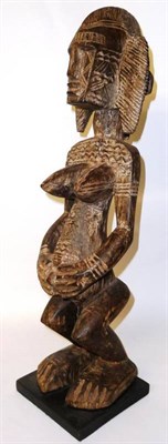 Lot 280 - A Dogon Carved Wood Fertility Figure, as a woman with block face and fanned crested coiffure, large