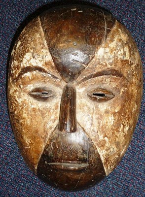 Lot 286 - A Fang, Gabon Wood Mask, the quartered face with small aquiline nose, raised oval slit eyes, pursed