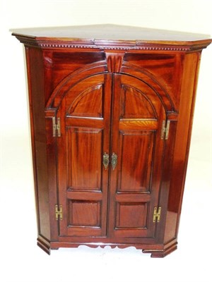 Lot 1547 - A George III Mahogany Freestanding Corner Cupboard, late 18th century, the moulded breakfront...