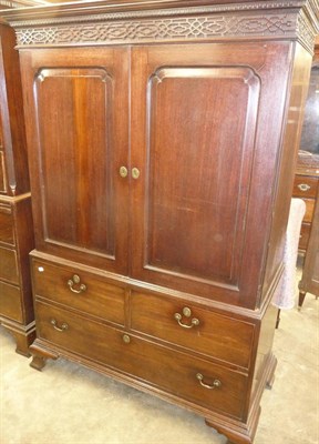 Lot 1550 - A George III Mahogany Linen Press, late 18th century, the dentil cornice above a blind fret...