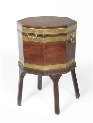 Lot 1553 - A George III Octagonal Mahogany and Brass Bound Cellaret on Stand, circa 1800, the hinged lid...