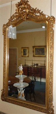 Lot 1558 - A Victorian Gilt and Gesso Overmantel Mirror, mid 19th century, the arched rectangular plate...