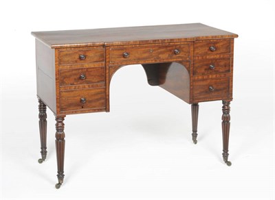 Lot 1563 - A George IV Kneehole Dressing Table, early 19th century, the rectangular breakfront top above a...