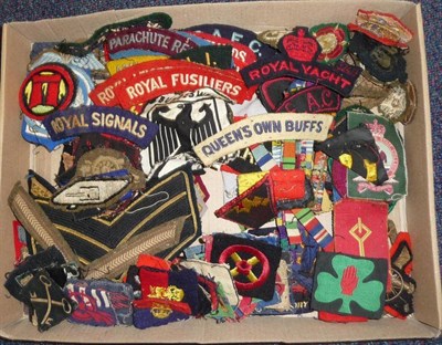Lot 60 - A Collection Military Cloth Insignia, comprising breast, arm, collar badges and shoulder...
