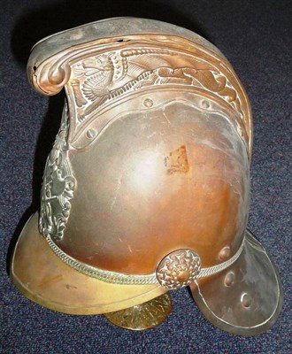 Lot 124 - An Edwardian Merryweather Style Brass Fire Helmet, with dragon embossed comb, the helmet plate...