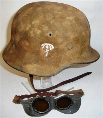 Lot 136 - A German Third Reich M35 Helmet, the shell covered in tan paint mixed with sand camouflage with...