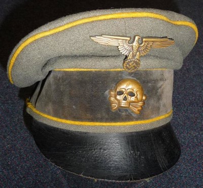 Lot 137 - A German Third Reich SS Enlisted Man's Visor Cap, in field grey wool, with yellow piping, black...