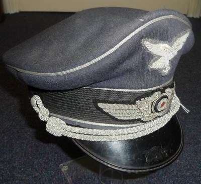 Lot 138 - A German Third Reich Luftwaffe Officer's Visor Cap, in blue grey wool with silver metal thread...