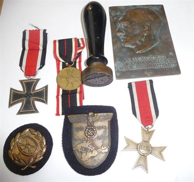 Lot 150 - A German Third Reich Iron Cross, second class, a War Merit Cross, a War Merit Medal, a Crimea...