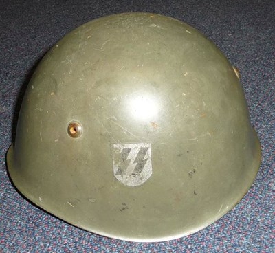 Lot 163 - A Second World War Italian M33 Combat Helmet, with single second pattern SS runes decal, with eight