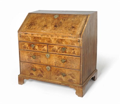 Lot 1580 - A George II Walnut and Feather Banded Bureau, second quarter 18th century, the fall enclosing a...