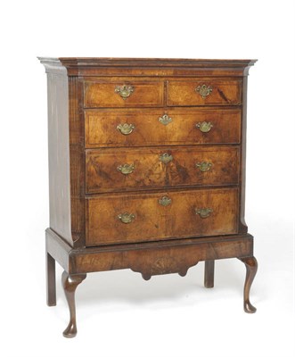 Lot 1582 - A Walnut and Feather Banded Chest on Stand, the crossbanded top above two short and three long...