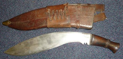 Lot 267 - A Second World War Kukri, with wood grip, leather scabbard and frog