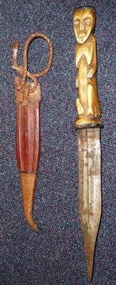 Lot 269 - An African Dagger, the pointed double edge steel blade with a narrow fuller to each side, the...