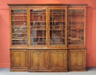 Lot 1590 - A George IV Mahogany Breakfront Bookcase, the quarter cushion moulded cornice over a plain...