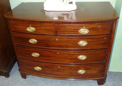 Lot 1591 - A George III Mahogany, Satinwood-Banded and Ebony Strung Bowfront Chest, circa 1800, with two short