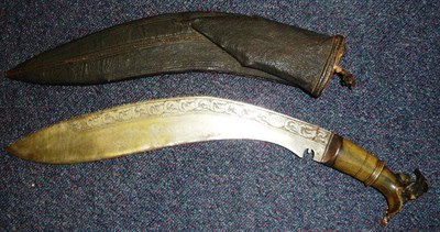 Lot 296 - An Indian Kukri, the curved steel blade engraved with a band of scrolling leaves along the back...