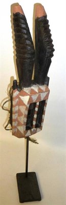 Lot 314 - A Dogon Walu Antelope Mask, 20th Century, the rectangular section head painted with orange and...