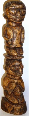 Lot 330 - A Liberian Bone Totemic Carving, as the figure of a man holding a sword and vessel, kneeling on the