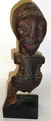 Lot 331 - A Songye Fertility Figure of a Woman, with domed skull and heart shape face on a long neck and...