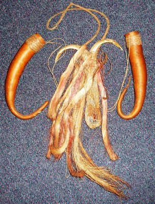 Lot 337 - A Highlands, Papua New Guinea Magic Bag, of a pair of boar's tusks set into the netted...