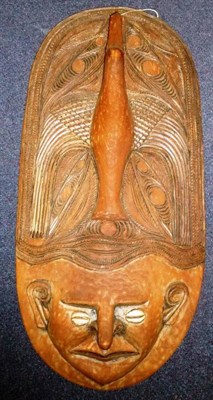 Lot 342 - A Coastal Region, Papua New Guinea Large Wood Plaque, of oblong form, carved as the mask of a...