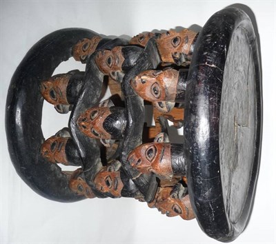 Lot 346 - A Bamileke, Cameroon Anthropomorphic Stool, carved from a single trunk of wood, the circular...