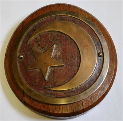 Lot 103 - A 19th Century Turkish Brass Cannon Roundel, the raised star and crescent moon on a red painted...