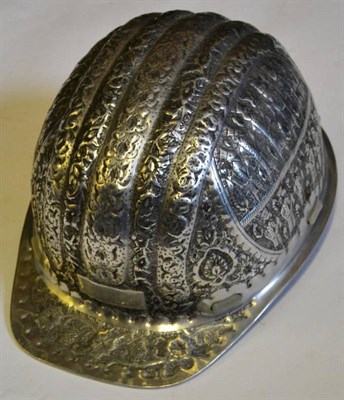 Lot 156 - A Persian Aluminum Site Supervisor's Helmet, embossed with figures and bands of foliage, with...