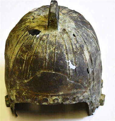 Lot 158 - A Chinese Western Zhou Style Bronze Helmet, with angular lug to the panelled crown, 31cm high.