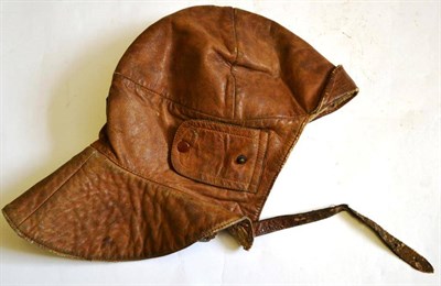 Lot 159 - A British Leather Flying Helmet, the folding peak and ear flaps with original press studs, the...