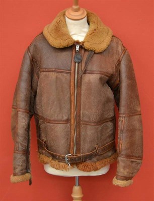 Lot 168 - A Second World War Sheepskin Flying Jacket, the front leather tabbed zip pull stamped...