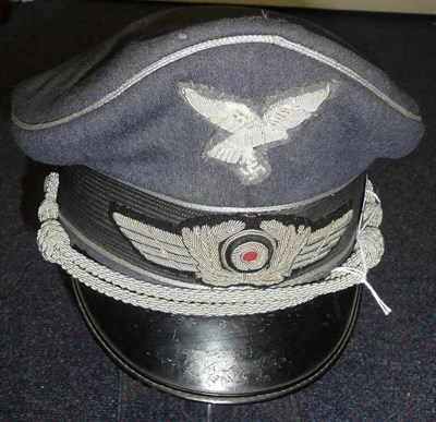 Lot 179 - A German Third Reich Luftwaffe Officer's Visor Cap, in blue grey wool with silver metal thread...