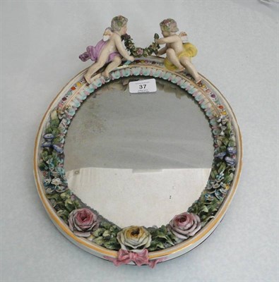 Lot 37 - A German (Plaue) Encrusted Porcelain Dressing Table Mirror, circa 1890, oval, applied to the...