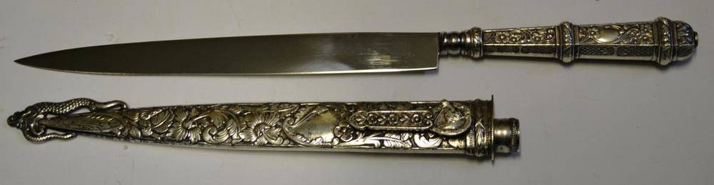 Lot 311 - A Brazilian Gaucho Knife, with 20cm Inox steel blade, foliate embossed silver coloured metal...