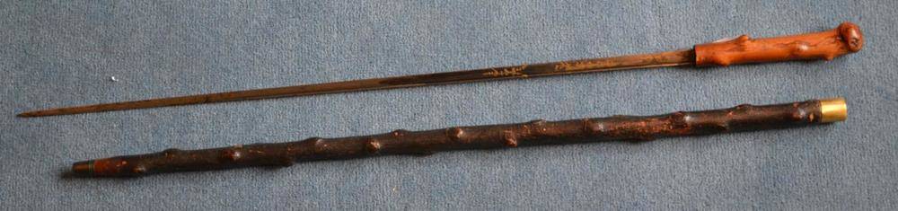Lot 322 - A Georgian Sword Cane, the 66.5cm single edge half blued steel blade with a narrow fuller to...