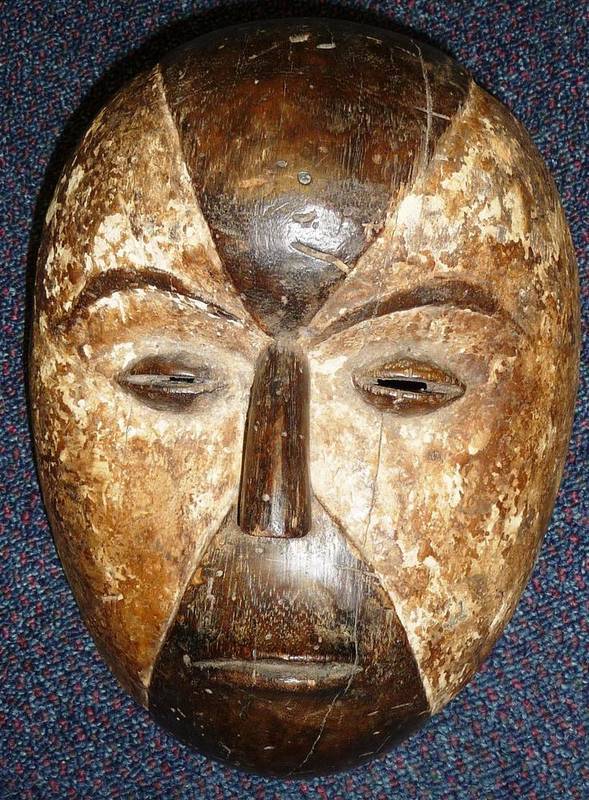 Lot 420 - A Fang, Gabon Wood Mask, the quartered face with small aquiline nose, raised oval slit eyes, pursed