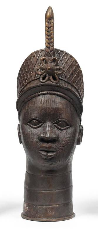 Lot 454 - A Benin Brass Head of a Princess, Nigeria, hollow cast, wearing a diapered diadem set with a floral