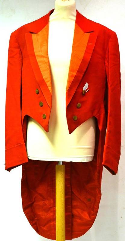 Lot 245 - An Early 20th Century Hunting Pink Tailcoat, with watered silk rever collar and brass buttons...