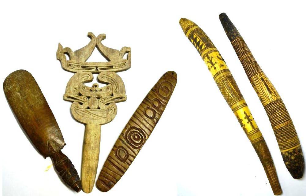 Lot 521 - An Australian Aborigine Bullroarer, one side carved with concentric circles, the opposing side with