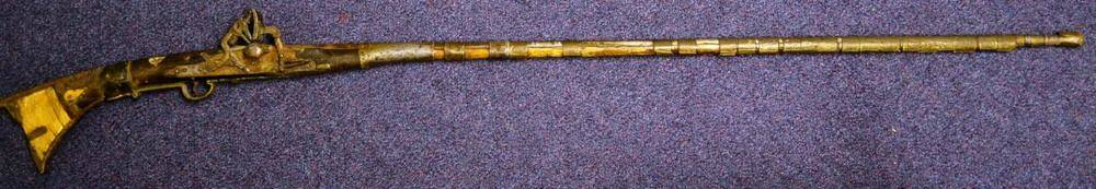 Lot 637 - A North African Snaphance Musket, the 120-cm steel barrel with sheet brass bands, wood stock inlaid