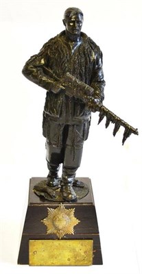 Lot 161 - A Bronzed Resin Figure of a British Soldier, standing holding a rifle and wearing camouflage,...