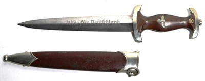 Lot 217 - A German Third Reich SA Dagger, the double edge steel blade etched Alles fur Deutschland, with...