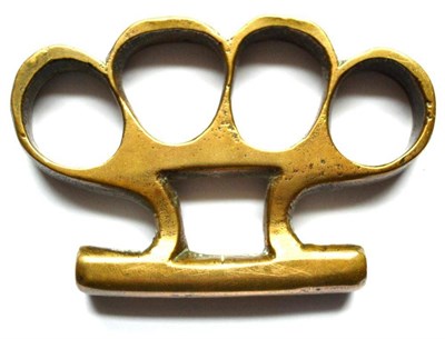 Lot 282 - A Brass Knuckleduster, with curved bar palm grip, 9.5cm