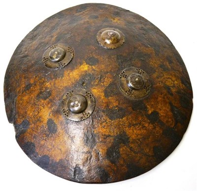 Lot 302 - A 19th Century Indian Hide Dhal, of domed circular form, with a faux tortoiseshell finish, four...