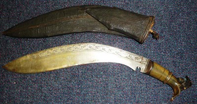 Lot 323 - An Indian Kukri, the curved steel blade engraved with a band of scrolling leaves along the back...