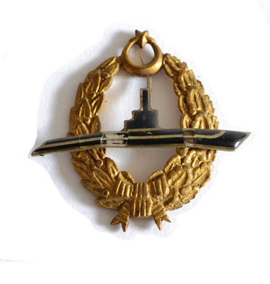 Lot 156 - A Turkish Submarine Badge, the oval brass laurel wreath set with a black enamelled submarine...