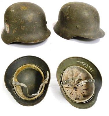 Lot 246 - A German Third Reich M35 Double Decal Police Combat Helmet, the left inner brim stamped Q64,...