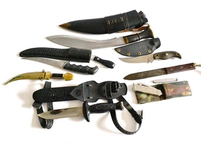 Lot 273 - An Indian Kukri, with horn grip and leather scabbard; four Various Fighting Knives, an Indian small